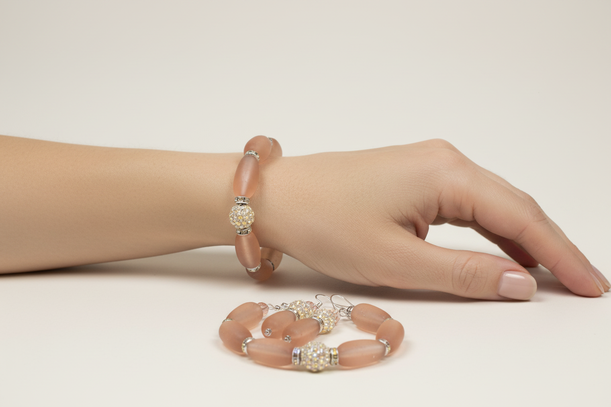 Lifestyle photo of Peachy Pink Vintage Glass Bracelet Set showing bracelet and earrings being worn together